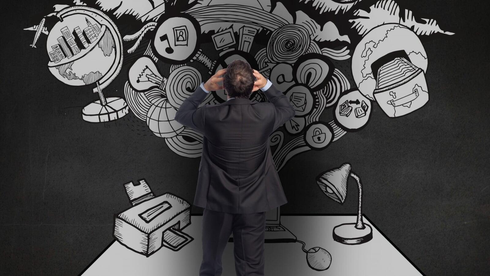 Rear view of a business professional standing at a desk surrounded by overwhelming hand-drawn illustrations and tangled ideas, representing how small daily financial habits can quietly build into larger business challenges