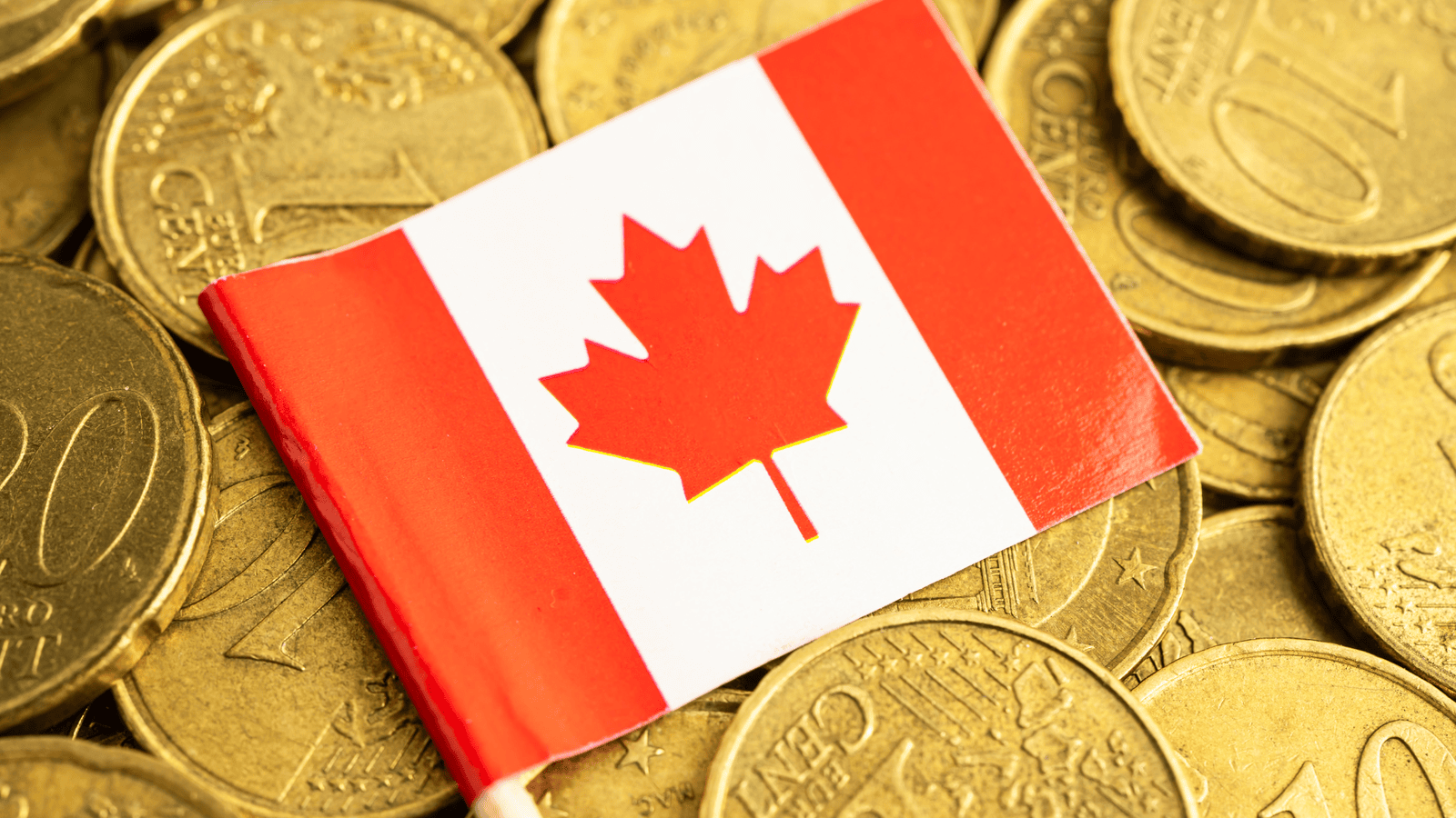 Canadian flag placed on coins representing important 2025 tax rule changes, updated tax rates, credits, and filing updates affecting personal taxpayers across Canada.