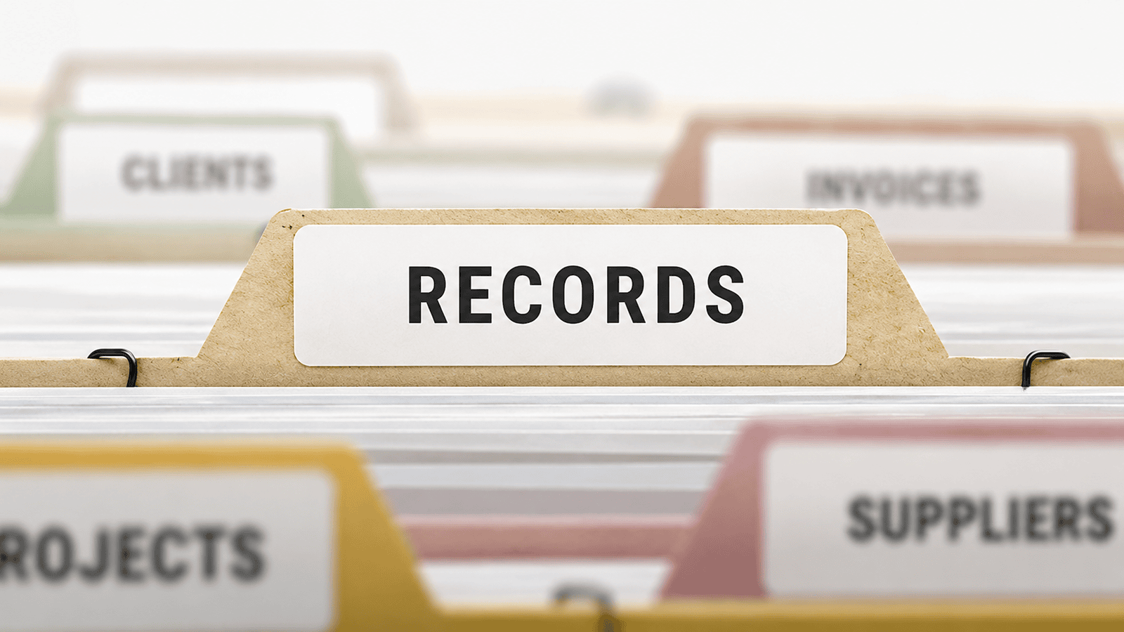 Close-up of organized filing folders with a prominent “RECORDS” tab, illustrating the importance of maintaining accurate business documentation for bookkeeping, tax planning, and CRA compliance for small businesses across Canada.