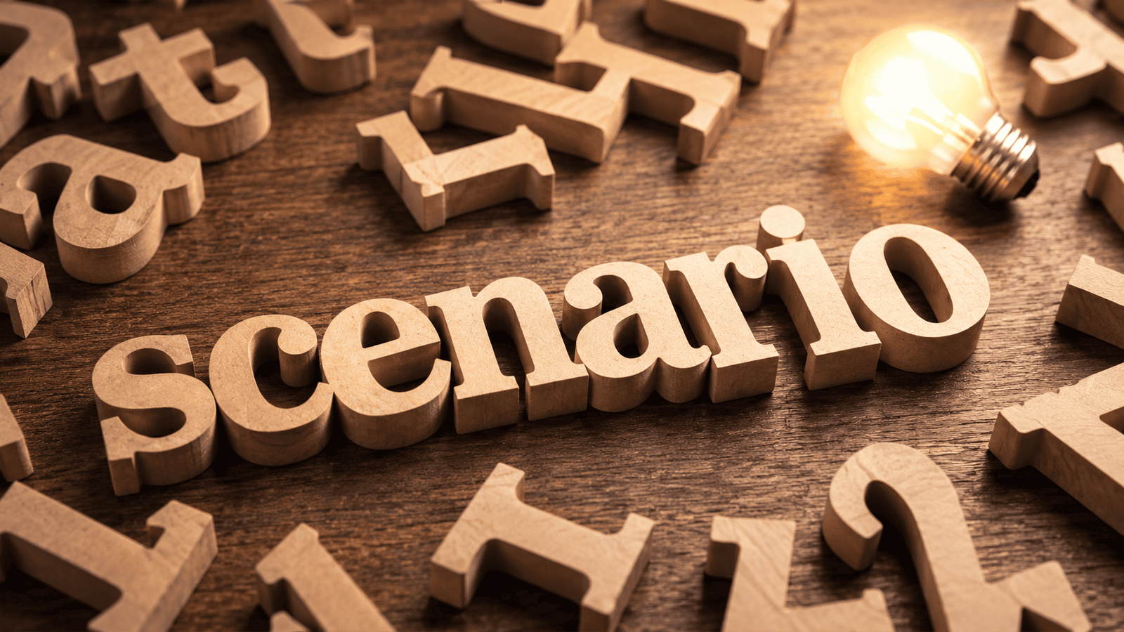 Wooden letters spelling scenario beside a glowing light bulb on a desk, representing a common corporate investing situation faced by incorporated business owners across Canada.