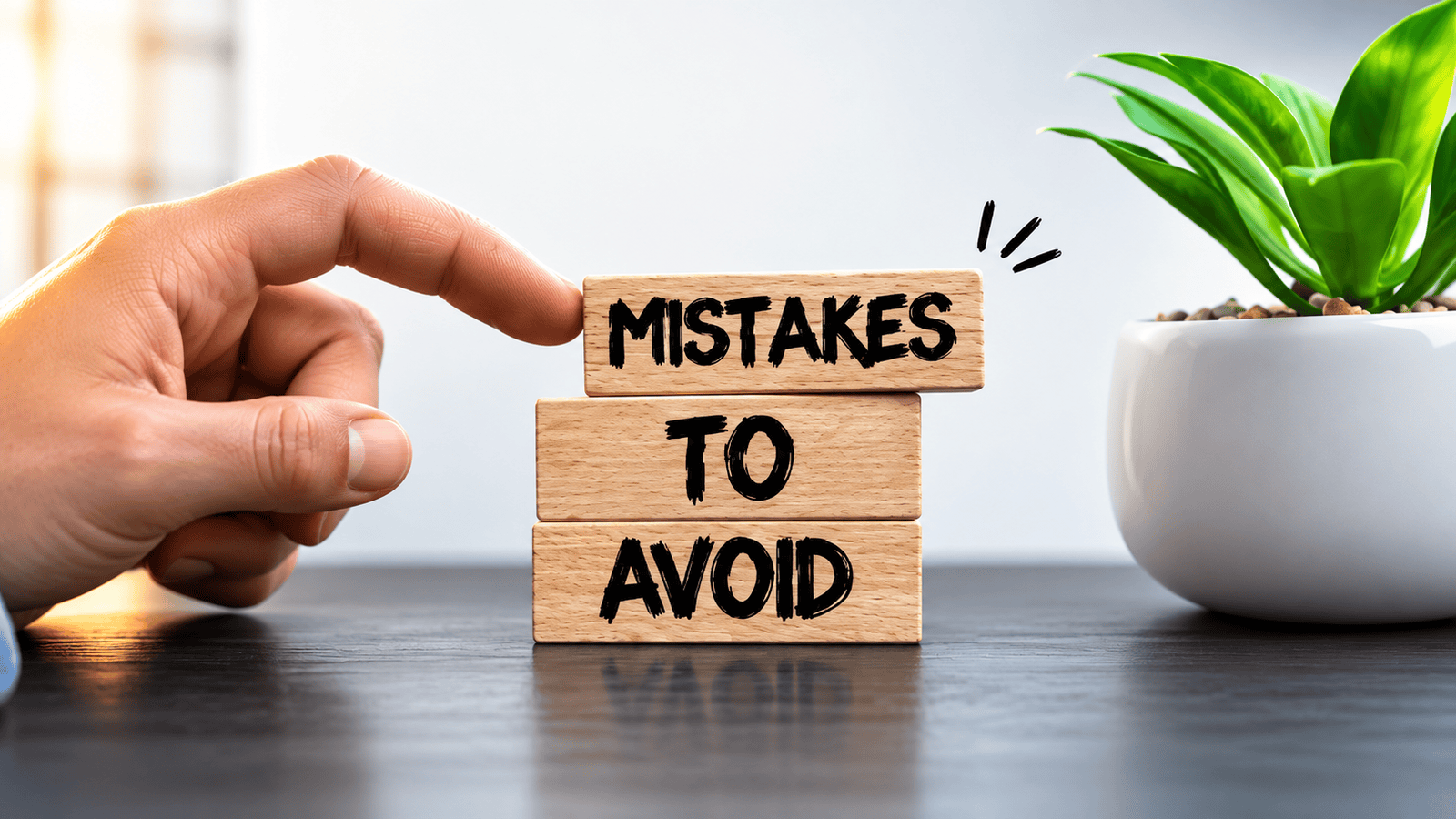Hand pointing toward wooden blocks reading ‘Mistakes to Avoid,’ representing common sales pipeline mistakes that can cause missed leads, weak follow-ups, and lost revenue for small businesses in London, Ontario.