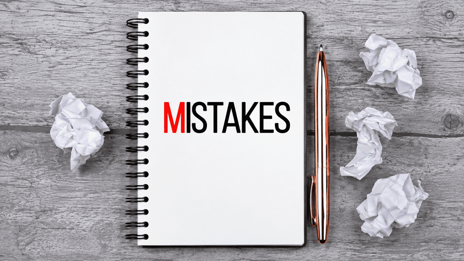 Notebook displaying the word ‘Mistakes’ beside crumpled paper, representing common financing errors that can weaken loan applications for small businesses in London, Ontario.