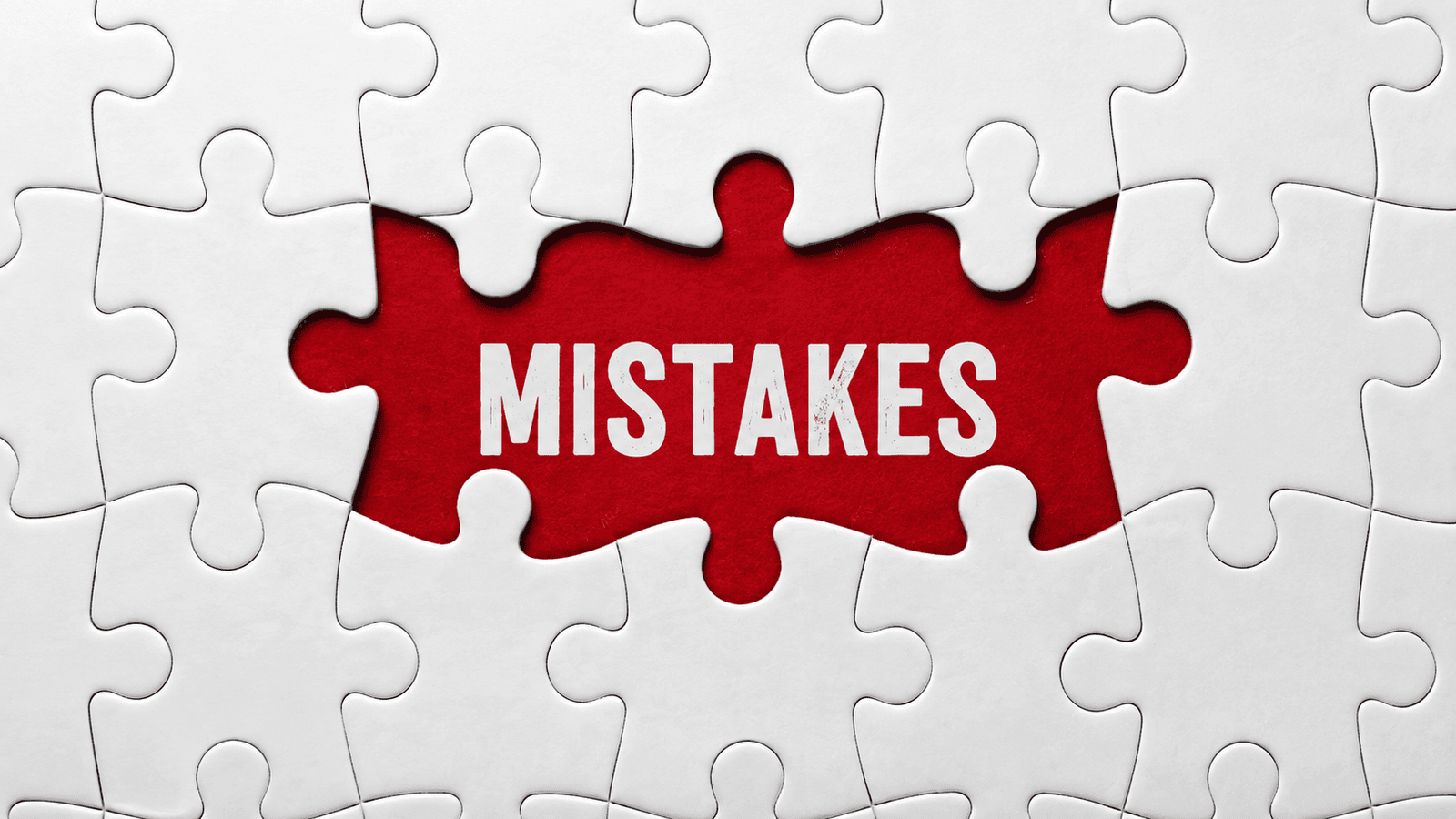 Red puzzle section displaying the word Mistakes among white puzzle pieces, representing common employee and independent contractor classification errors made by business owners in London, Ontario and across Canada.