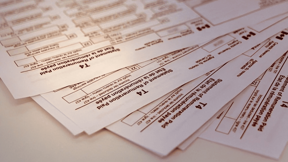 Multiple T4 slips stacked together used by Canadian employers to report employee income and payroll deductions to the CRA