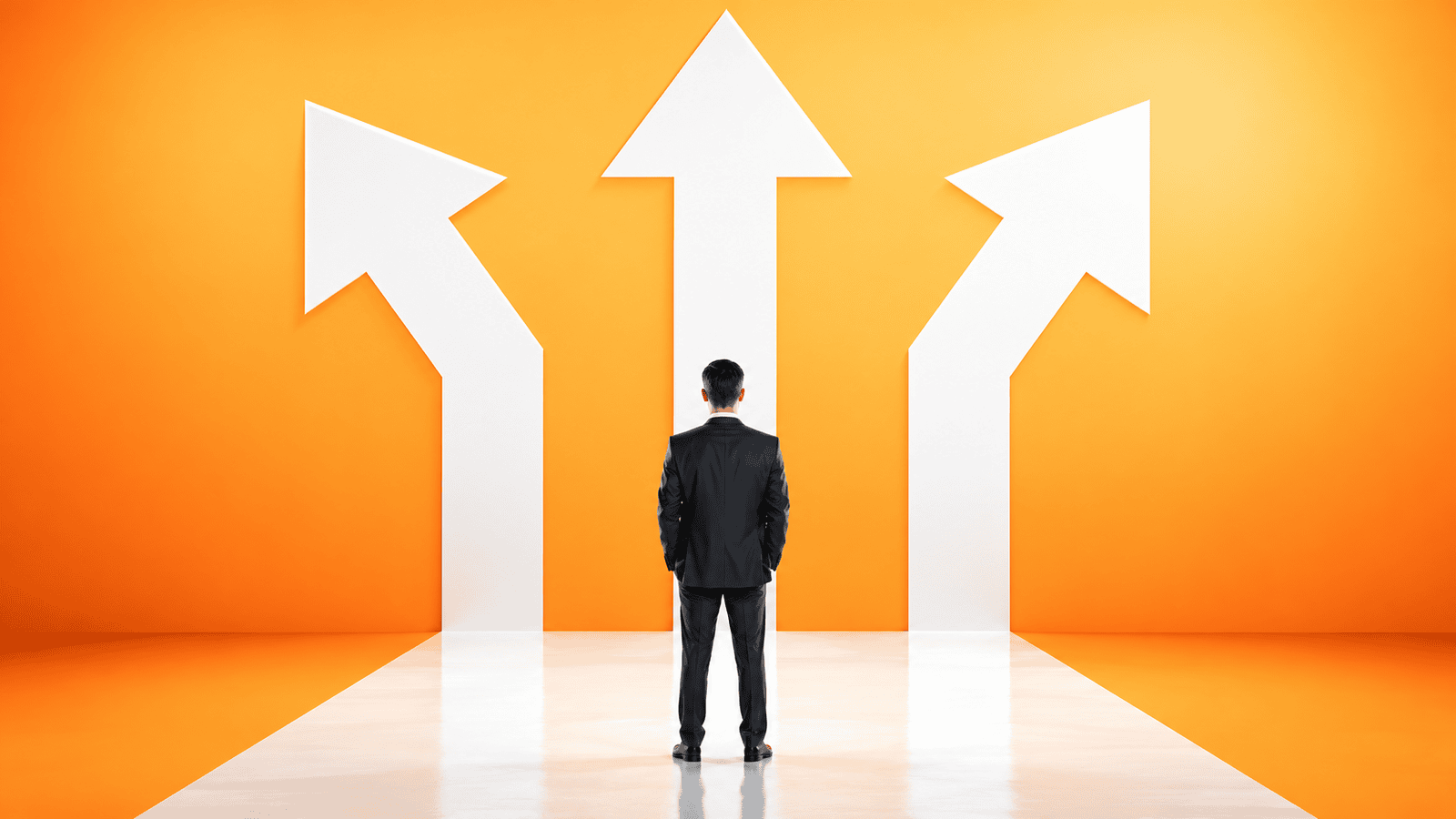 Businessman in a dark suit standing before three white arrows on an orange wall, representing the choice between salary, dividends, or no payment when paying family from a Canadian corporation.