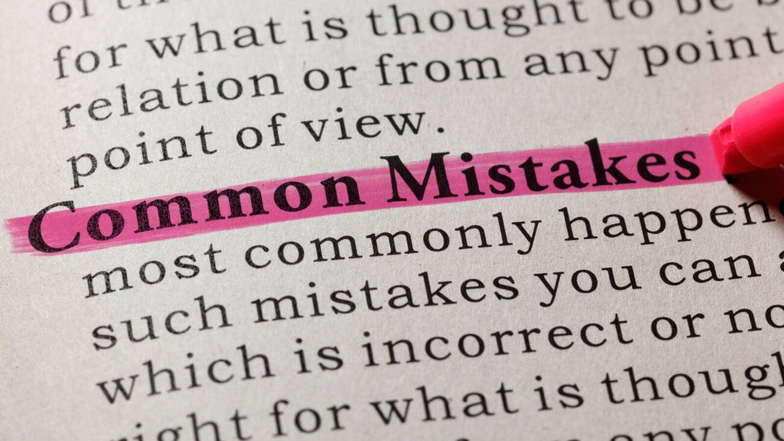 Close-up of the words “Common Mistakes” highlighted in pink on a printed page with a marker, representing frequent tax filing errors and compliance issues faced by small businesses in London, Ontario.