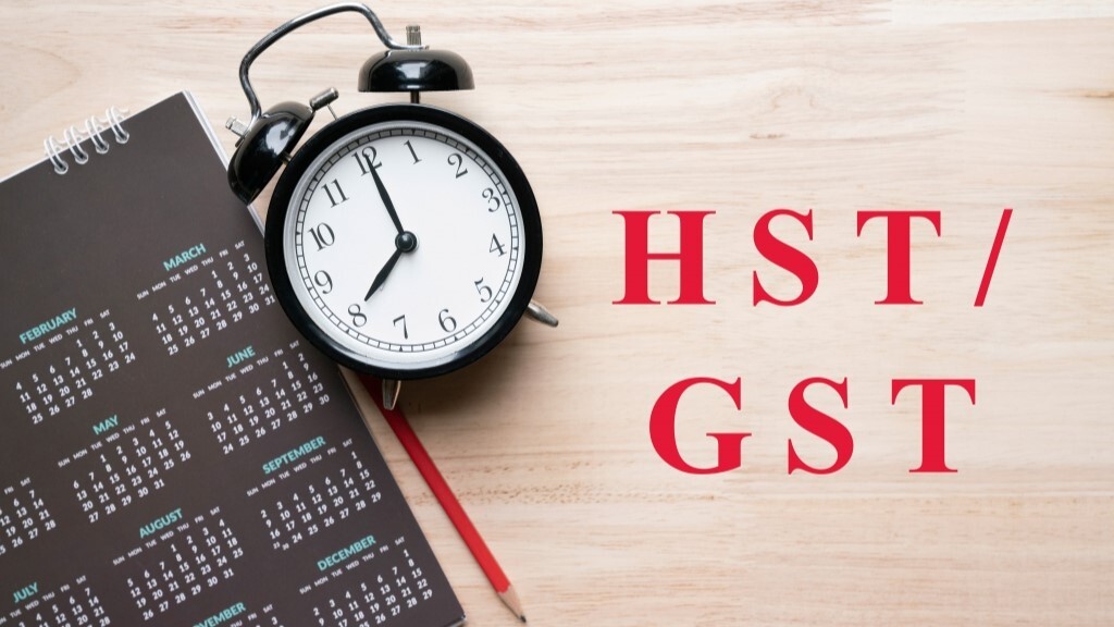 Alarm clock and calendar representing GST/HST registration deadlines for Canadian service businesses once taxable revenue exceeds the $30,000 small supplier threshold.