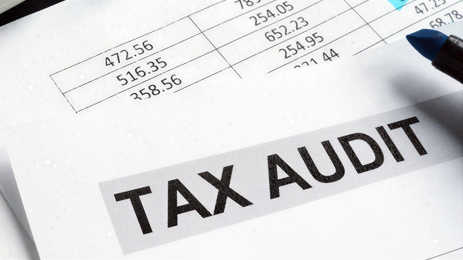 Close-up of a financial document labeled ‘Tax Audit’ with numerical data and a pen, representing a CRA audit process in Canada. Image illustrates review of income, expenses, and financial records for small businesses during a Canada Revenue Agency tax audit in Ontario.