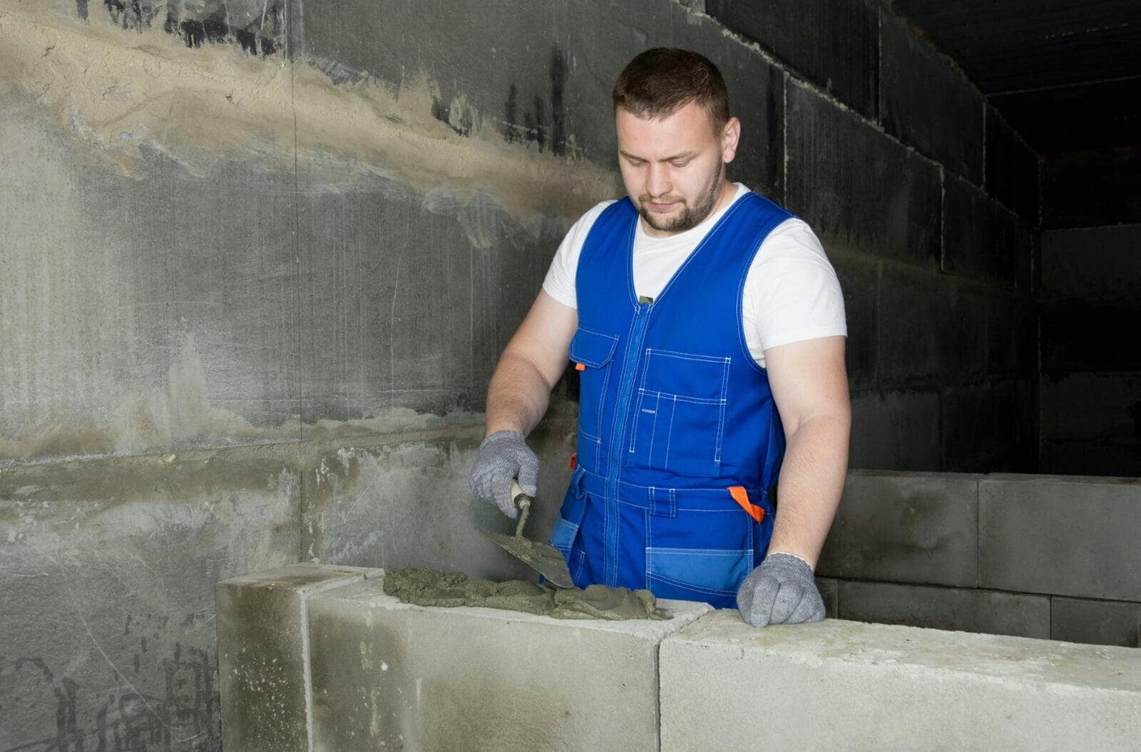 Masonry contractor working on a building construction project