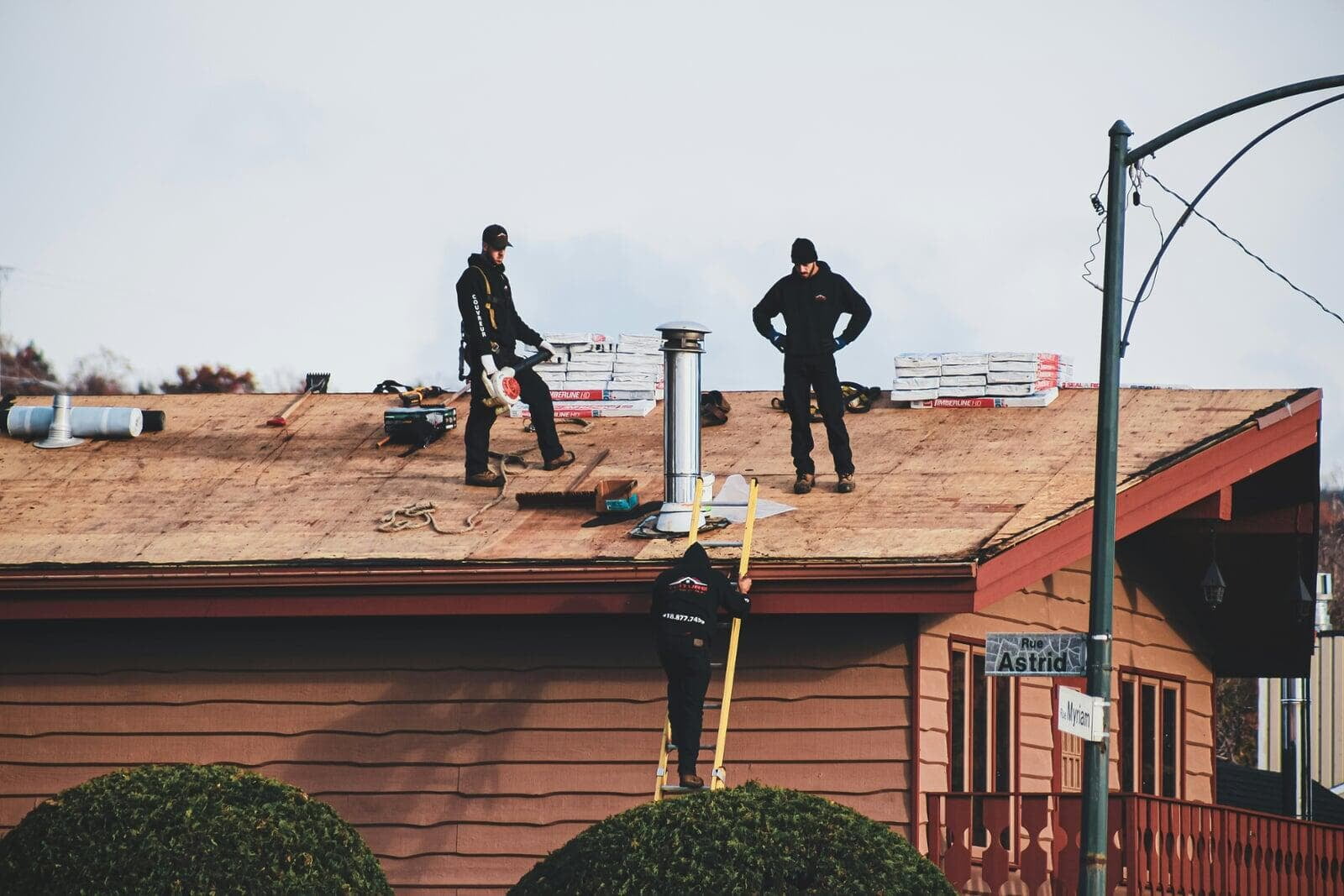 Roofing contractors working on a residential roofing project