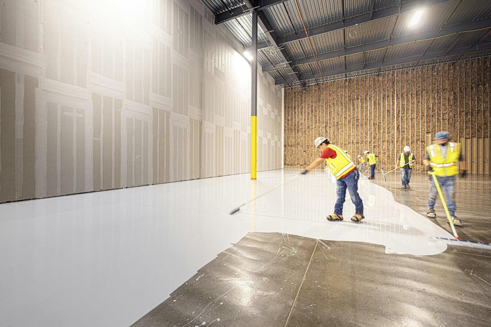 Flooring contractors installing flooring in a commercial building