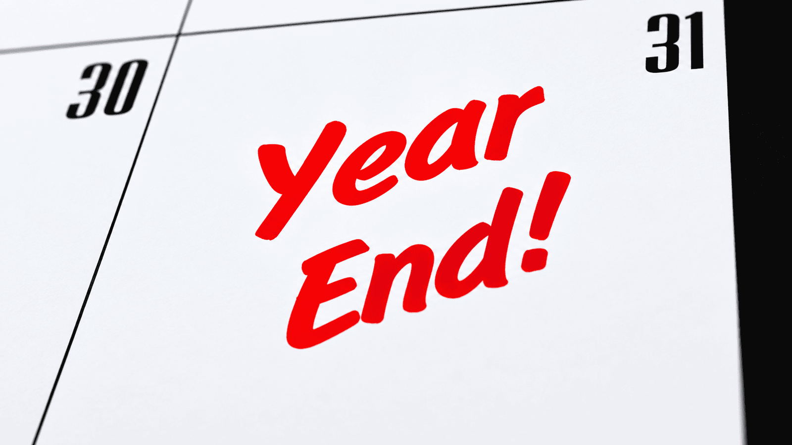 Close-up of a calendar marked ‘Year End!’ in red, representing a non-calendar corporate year-end and the timing flexibility available to Canadian businesses