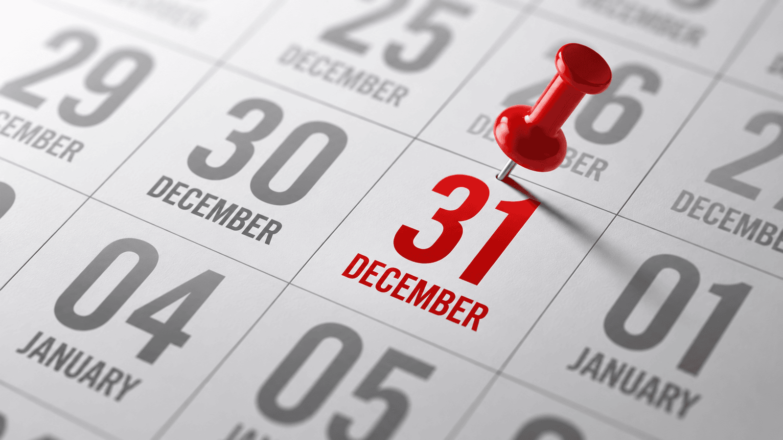 Close-up of a calendar highlighting December 31 with a red pushpin, representing the simplicity of using a calendar year-end for corporate reporting and tax planning in Canada.