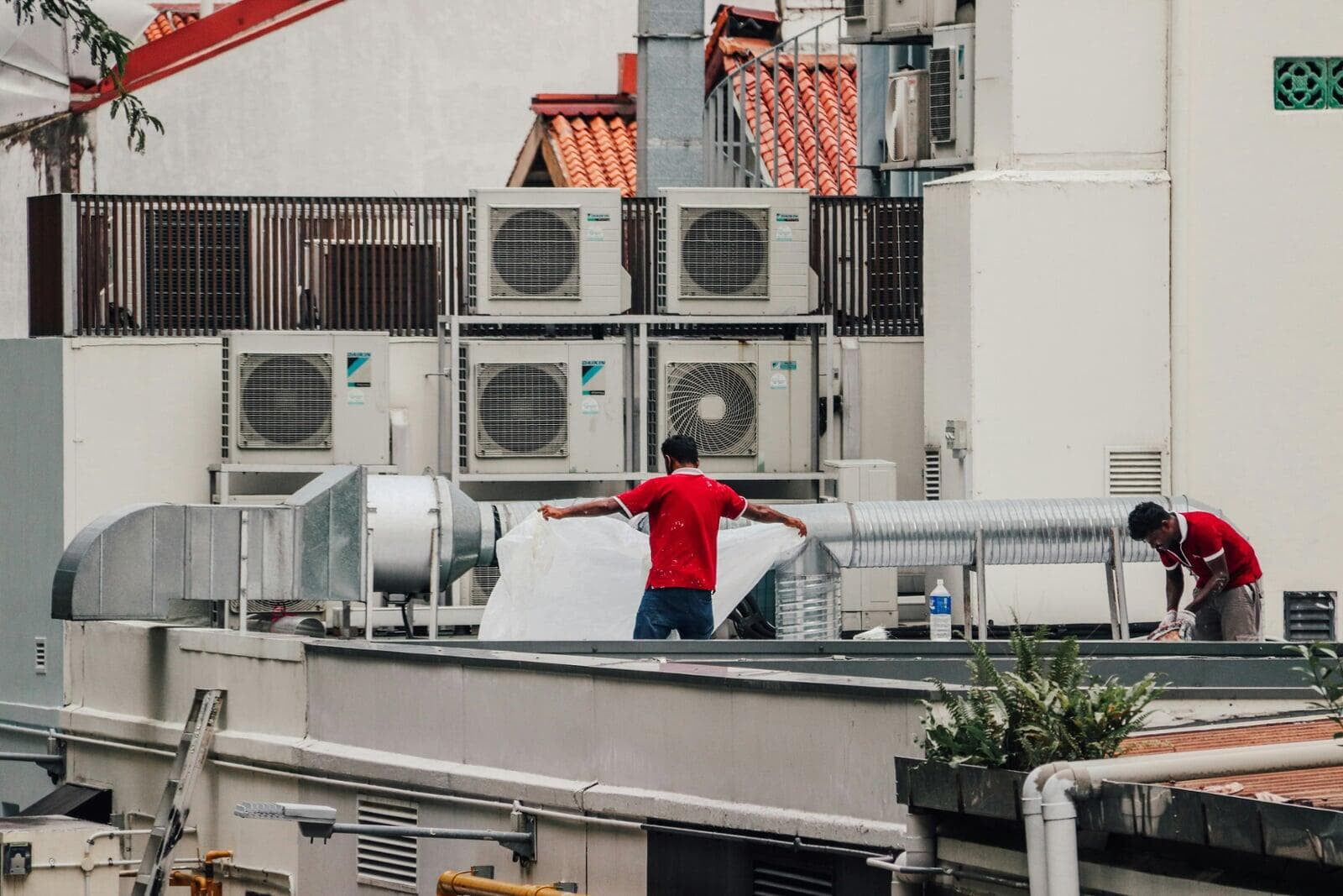 HVAC contractors working on commercial heating and cooling equipment