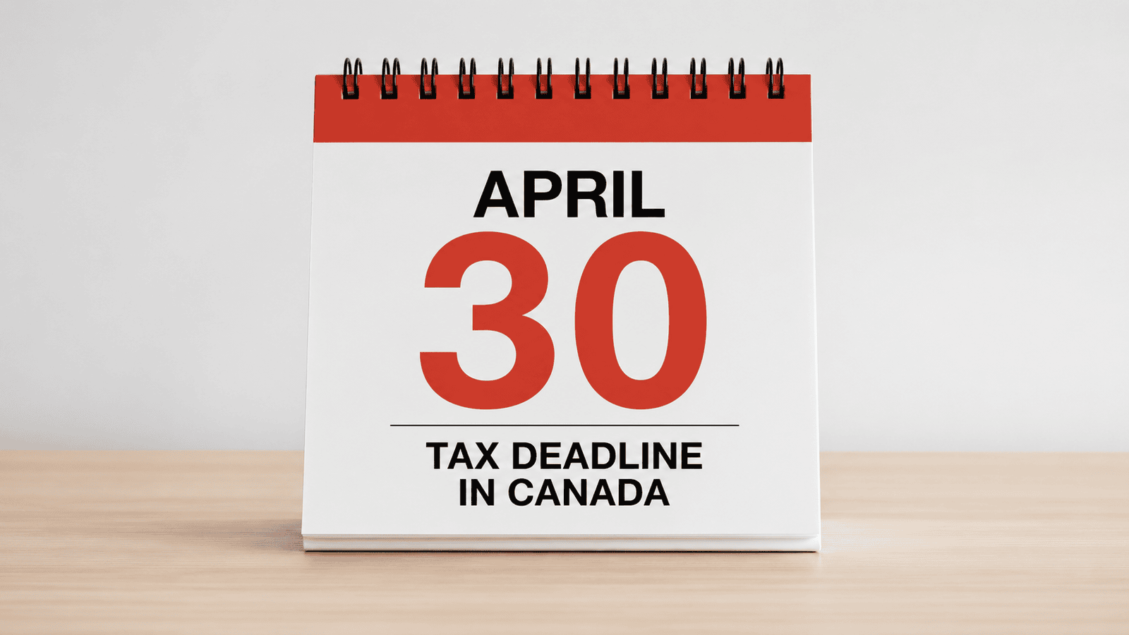Close-up of a desk calendar flipped to April with the 30th circled in red beside bold text highlighting the tax deadline, representing the importance of meeting filing obligations for individuals and business owners in Canada.