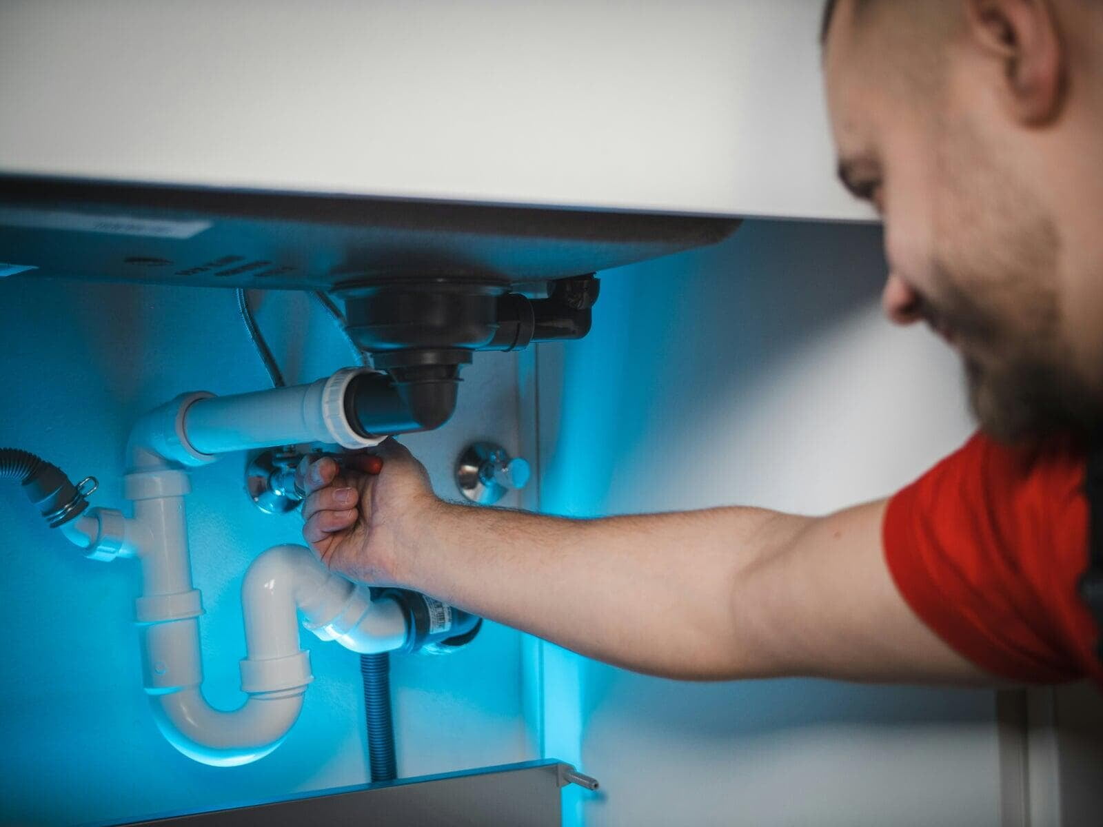 Plumbing contractor working on residential plumbing installation